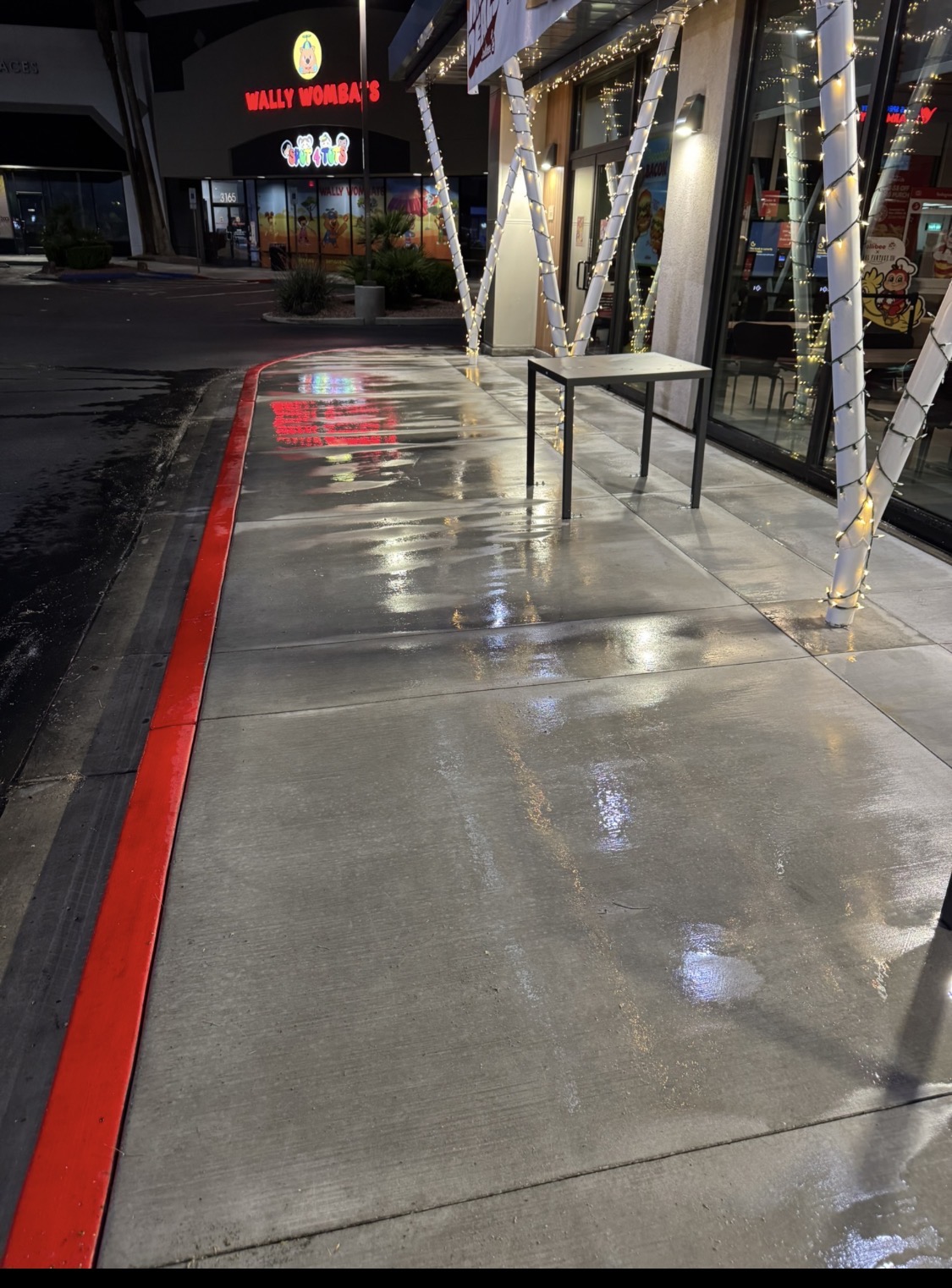 Same sidewalk after pressure washing, clean and bright